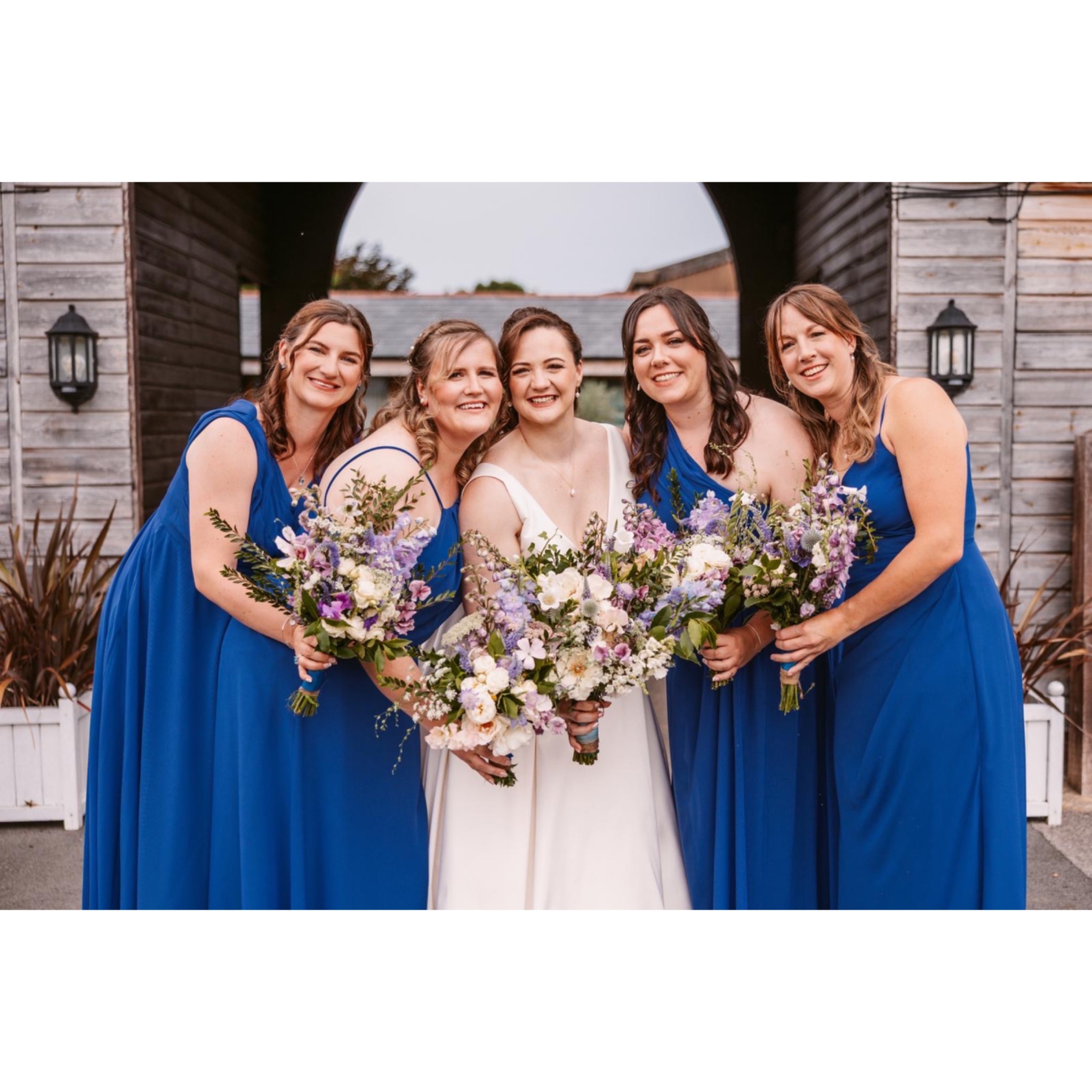 Bride with her bridesmaids on her wedding day