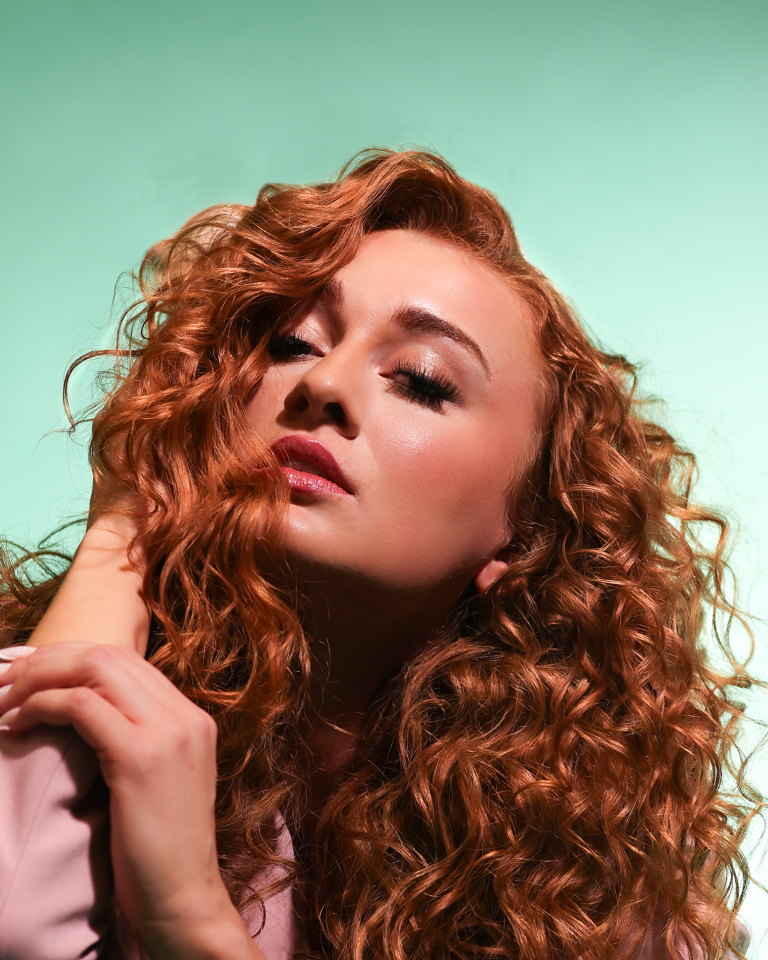 Copper-toned occasion makeup on a red-haired model