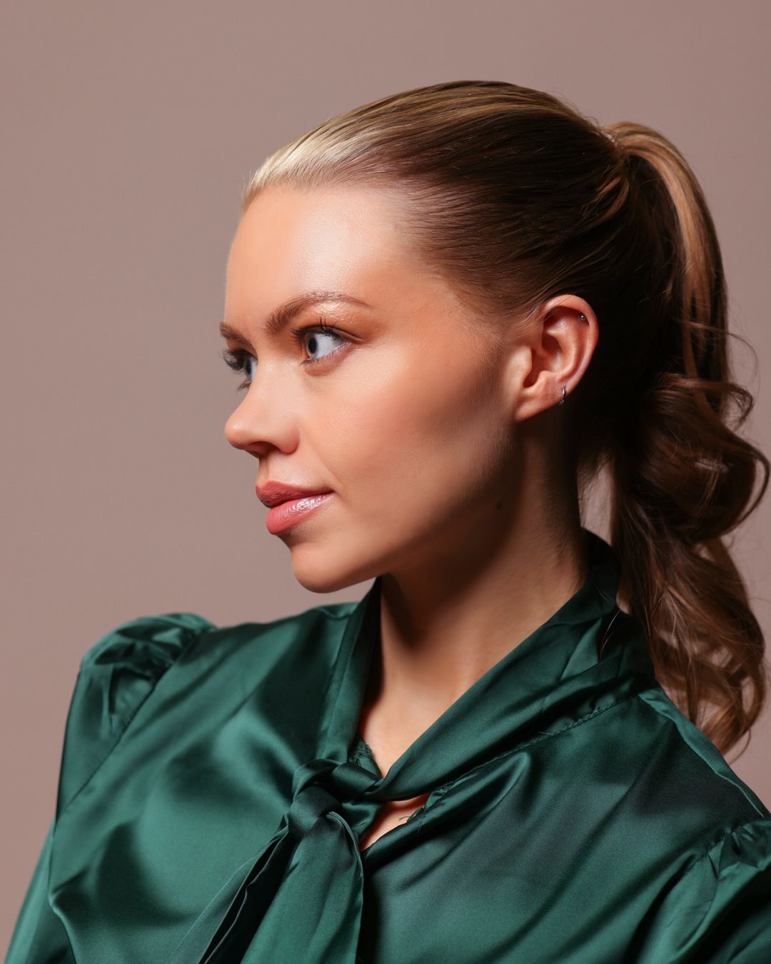 Soft glam occasion makeup with a sleek ponytail